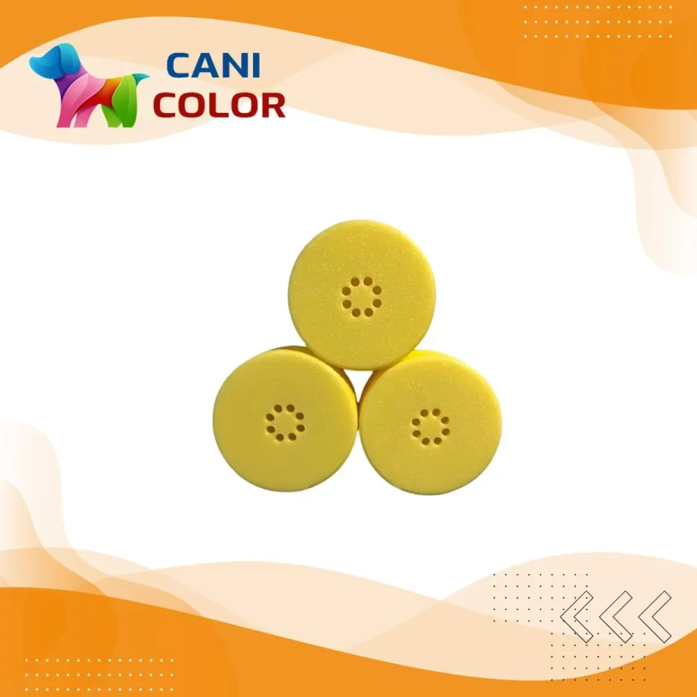 Three yellow circular items arranged in a triangular formation, featuring small holes in the center.